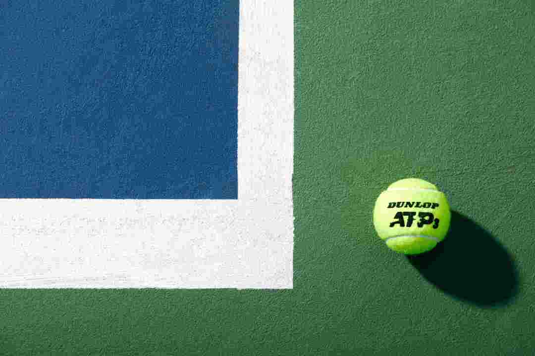 Dunlop tennis ball by the baseline