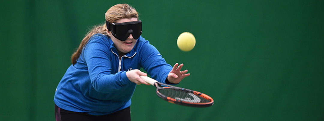Visually impaired woman playing tennis