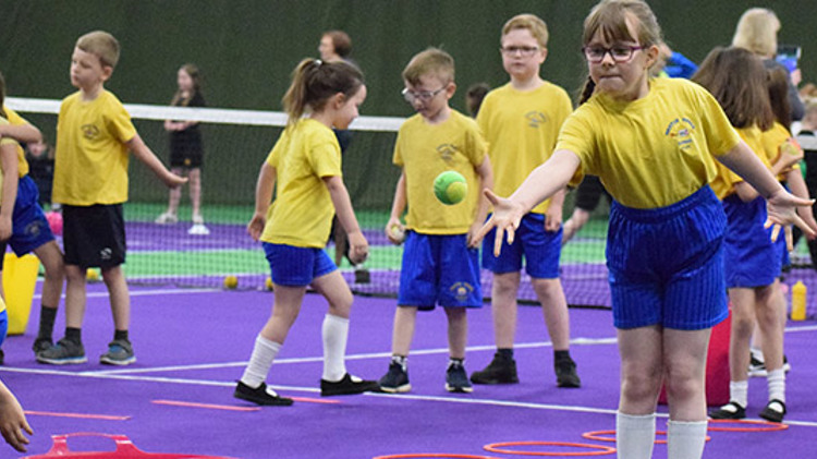 Children at a tennis coaching session