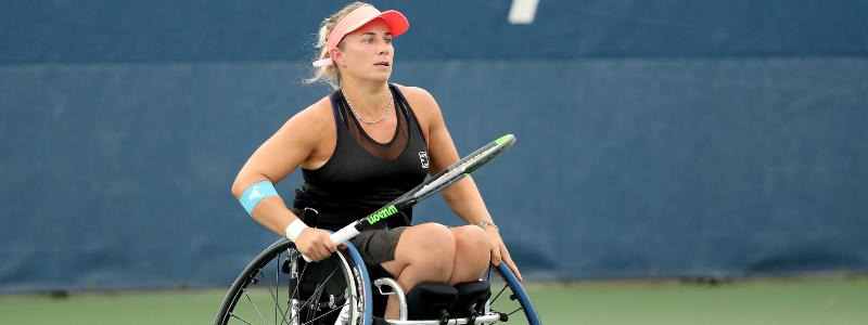 Lucy Shuker on court holding racket