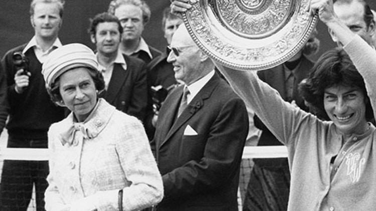 black and white image of virginia wade holding winners trophy and the queen on the left of her