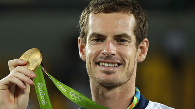 Andy Murray smiling with a Rio 2016 gold medal at the olympics