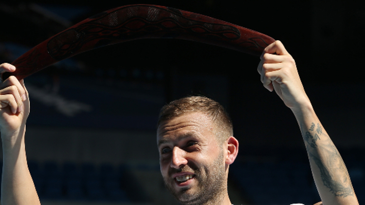 Dan Evans holds a boomerang in the air after winning Murray River Open