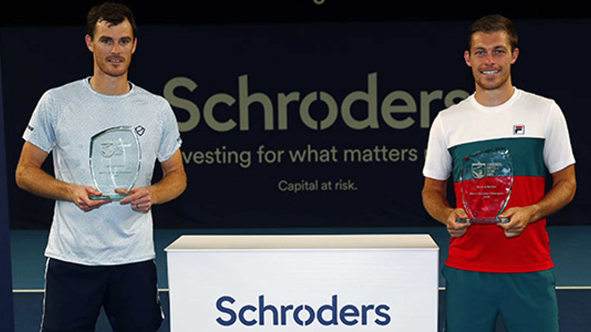 Jamie Murray and Neal Skupski holding their awards