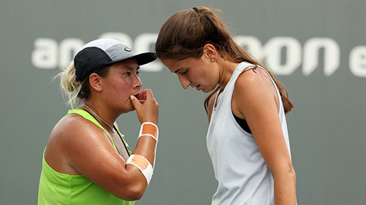 Tara Moore and Emina Bektas meet during their doubles match in Lexington