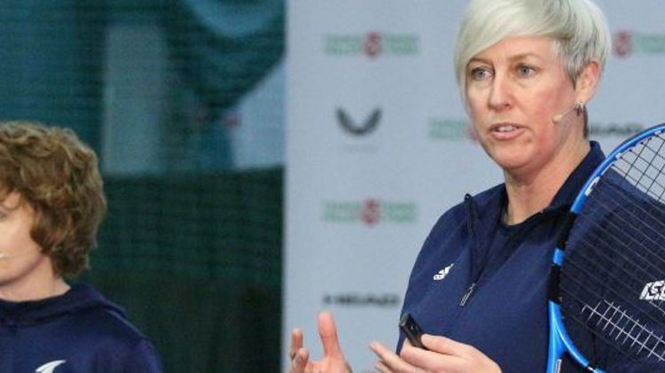 Jo Ward and Suzanne Williams standing next to each other with a tennis racket