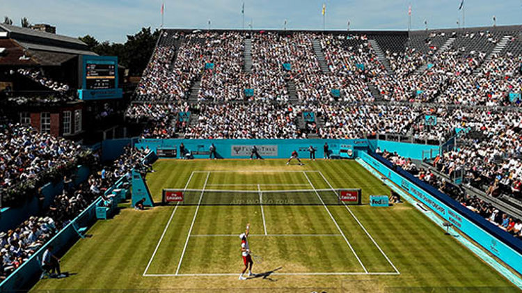 birds eye view of grass courts at fever tree with woman's singles match  being played